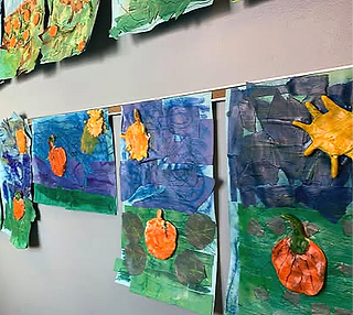fall art of pumpkin patch displayed on school wall
