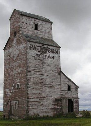 old elevator barn with cloudy sky
