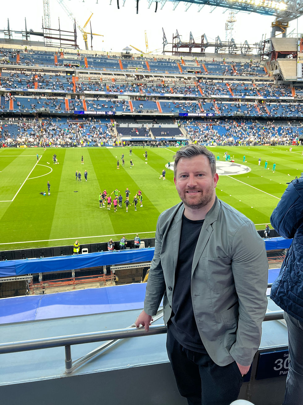 Portrait photo of Matthew Rea standing in a football stadium