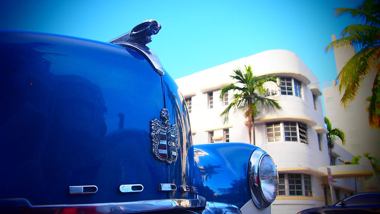 Vintage luxury car driving down Ocean Drive in Miami