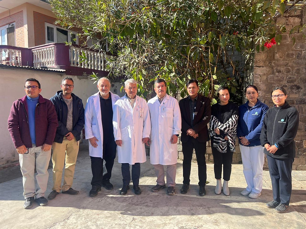Group photo of Dr. Aram Akopyan and Dr. Ram, Founder and Chief Executive of Dhulikhel Hospital, with students and hospital physicians outside Dhulikhel Hospital in Nepal during the EIIHS collaboration.