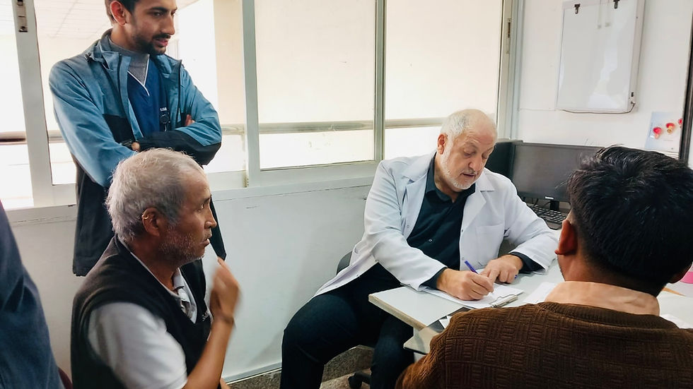 Dr. Aram Akopyan providing integrative acupuncture and Traditional Chinese Medicine (TCM) care within a hospital clinical environment at Dhulikhel Hospital in Nepal.