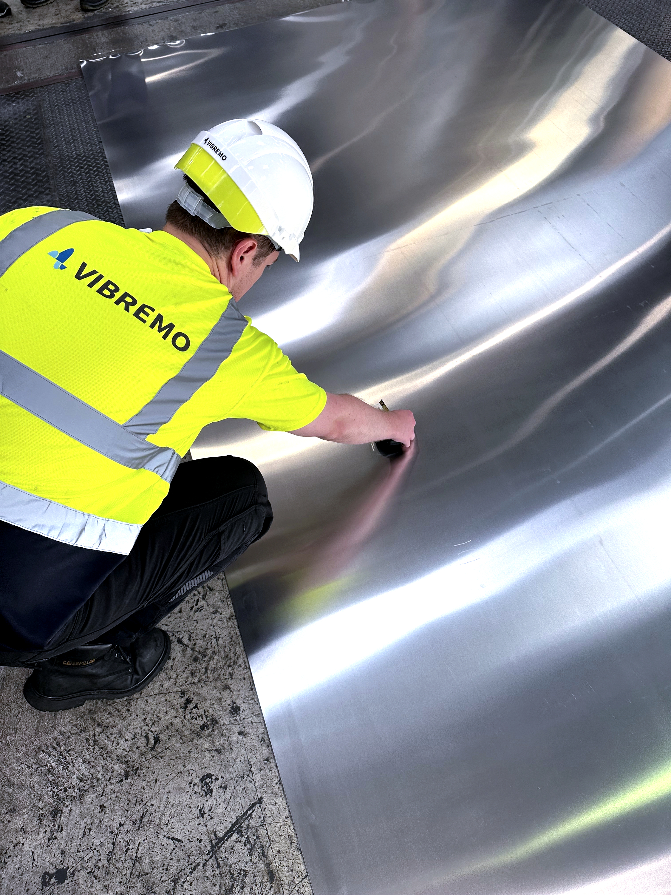 Vibremo engineer inspecting marks on strip