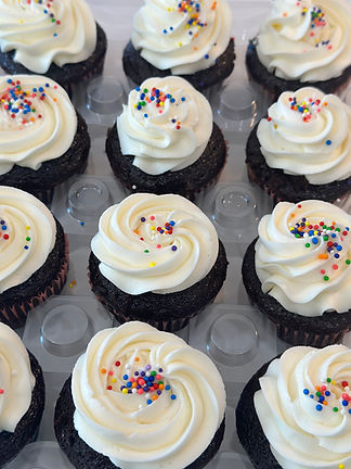 Delicous chocolate cupcakes toped with swiss buttercream and festive sprinkles