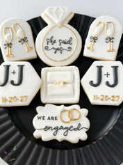 Elegant Black, White and gold engagement cookies. 