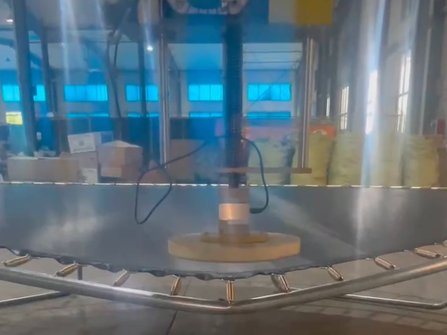 The static load applicator positioned over the trampoline bed during ASTM testing