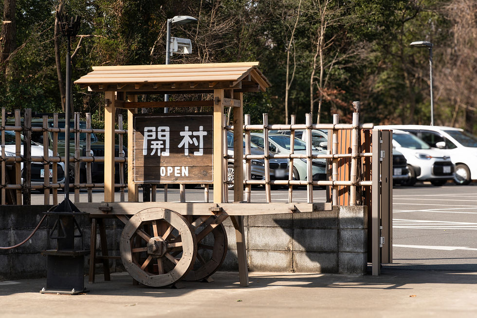 木製のサイン「開村 OPEN」があり、古い荷車の上に置かれています。背景には駐車中の車と木々が見えます。晴天の日。第八車。