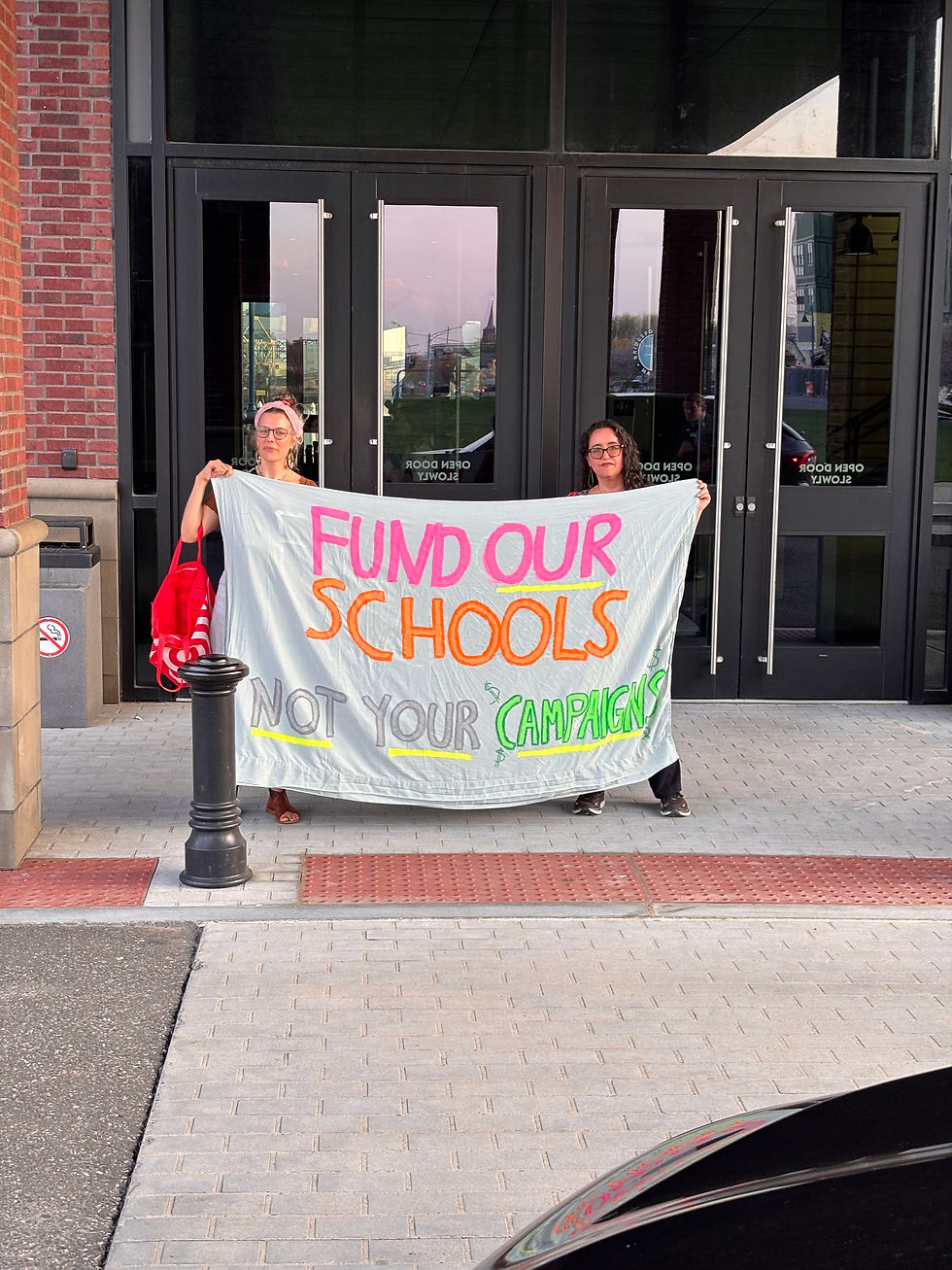 Callie Heilmann and Ilana Ofgang protesting at Mayor Joe Ganim's first re-election fundraiser where Gov. Ned Lamont was the featured guest. 