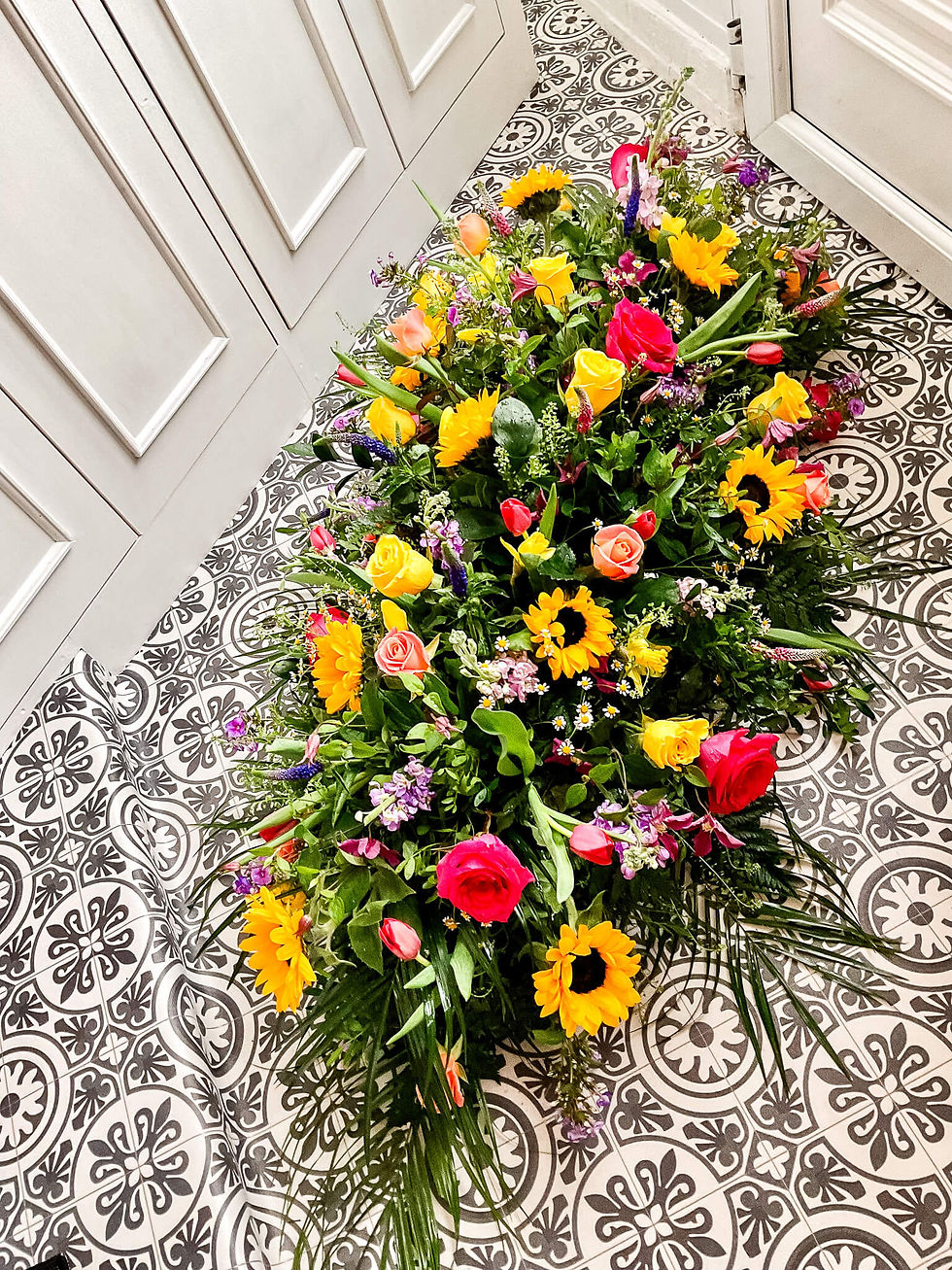 Yellow pink funeral casket spray_Blooms Floristry