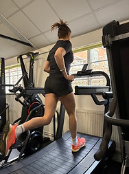 Client running on a manual treadmill during a personal training session