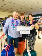Family holding a welcome sign, Mr WOARCHICH, at the Sri Lanka airport