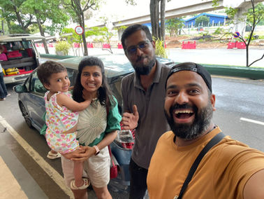 Group selfie smiling together with a child at the street. Friendly Tour Driver.
