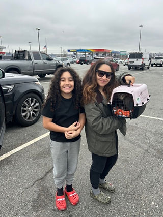 Mom and daughter with their cat in a cat carrier