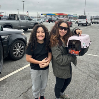 Mom and daughter with their cat in a cat carrier