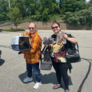 two women with cats in cat carriers