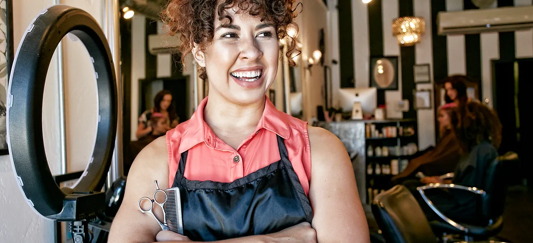 women in her salon happy after taking online business skills courses