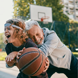man and boy playikng basketball
