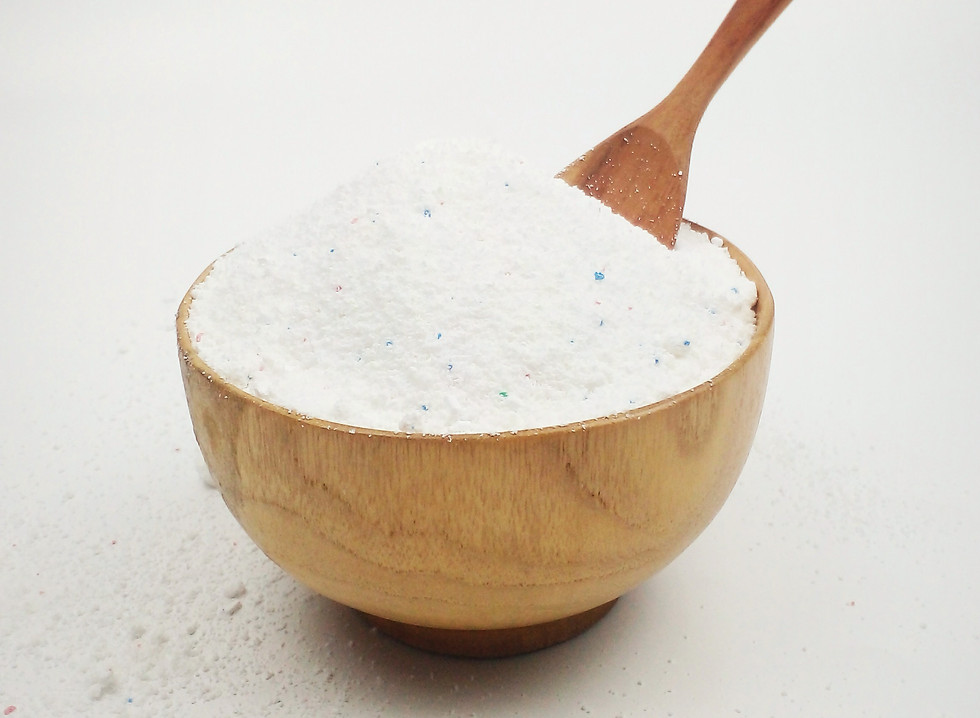 Wooden bowl of white salt with a wooden spoon, illustrating microplastics risk from plastic salt grinders