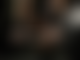 (Style: Dynamic, close-up photograph). Description: A shot from a low angle, focused on a person's hands gripping a heavy barbell during a deadlift or squat. The face is obscured, but the tension and determination in the hands and forearms are highly visible, emphasizing the act of struggle and commitment.