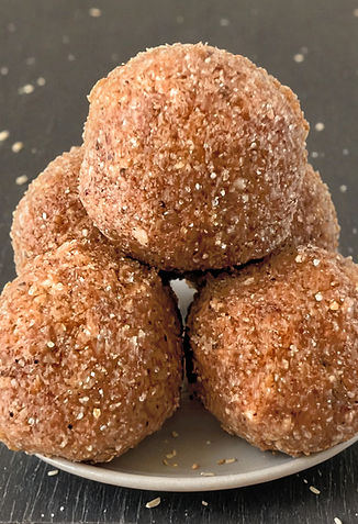 Round Punjabi Pinnis made from whole wheat and ghee, placed close together on a plate, with a rich, nutty brown color