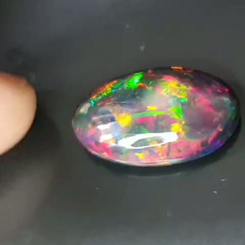 Thumbnail: 10.84 ct Natural Opal black with amazing playoff color oval loose gemston