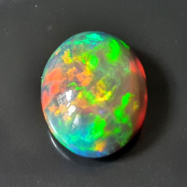 Thumbnail: 8.15 ct Natural Opal black with amazing playoff color oval loose gemston
