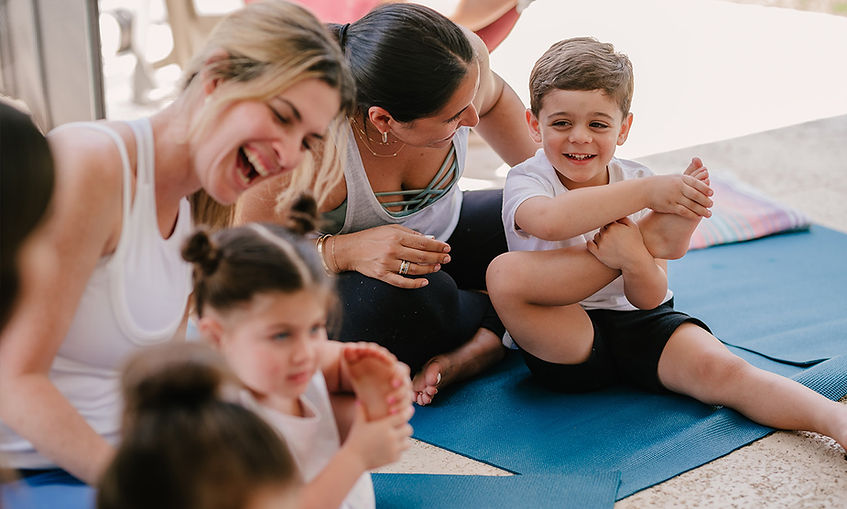 Moms with their children age 4-5 at Namaste and Play kids yoga class.
