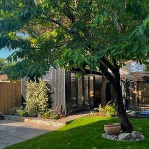 Small family-friendly urban garden design with patio and garden room in Northfields, West London