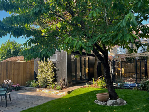 Small family-friendly urban garden design with patio and garden room in Northfields, West London