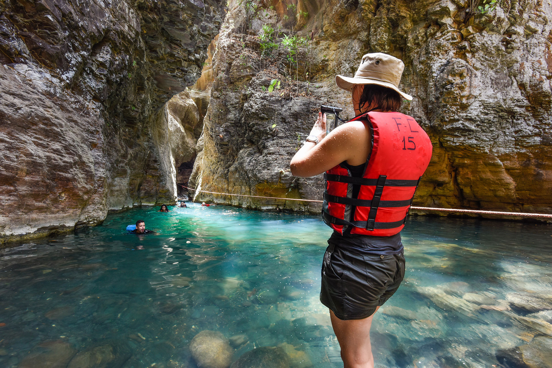 Visitors enjoying La Leona Waterfall during a guided hike with Finca Curubanda.