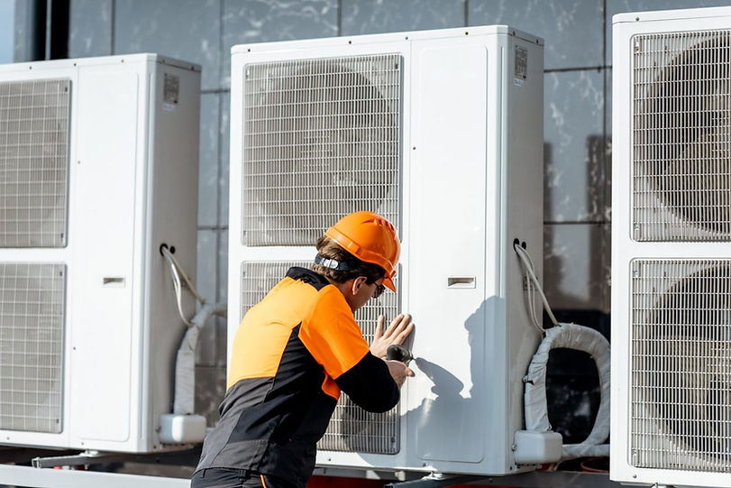 workman-installing-outdoor-unit-of-the-air-conditioner-e1621836841610.jpg