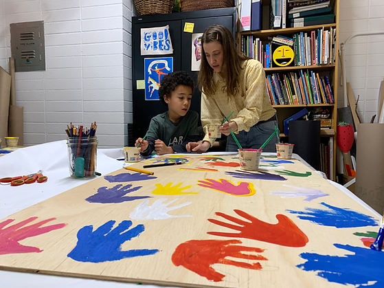 jamia painting hands with boy.png