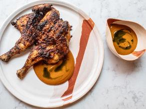 Spatchcock poussin with pepper spice on a white plate