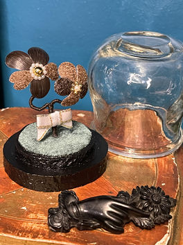 Pansy flowers made from human hair, using the palette hairwork technique and pulverized hair. With its base and glass dome.