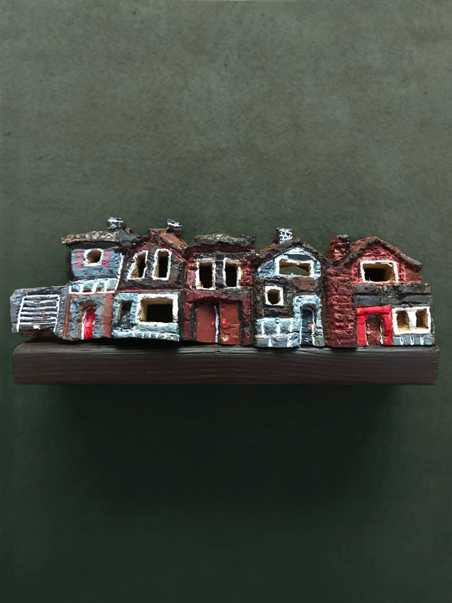 A wood carving of a row of five houses inspired by the film 'Billy Elliot'