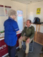 Our Parish Nurse monitoring blood pressure at a  Farmers Market