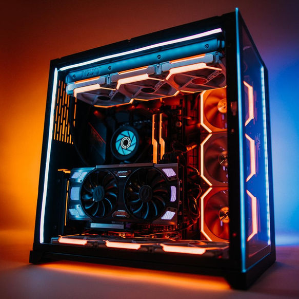 Gaming PC desktop computer case with internal orange and blue lighting.