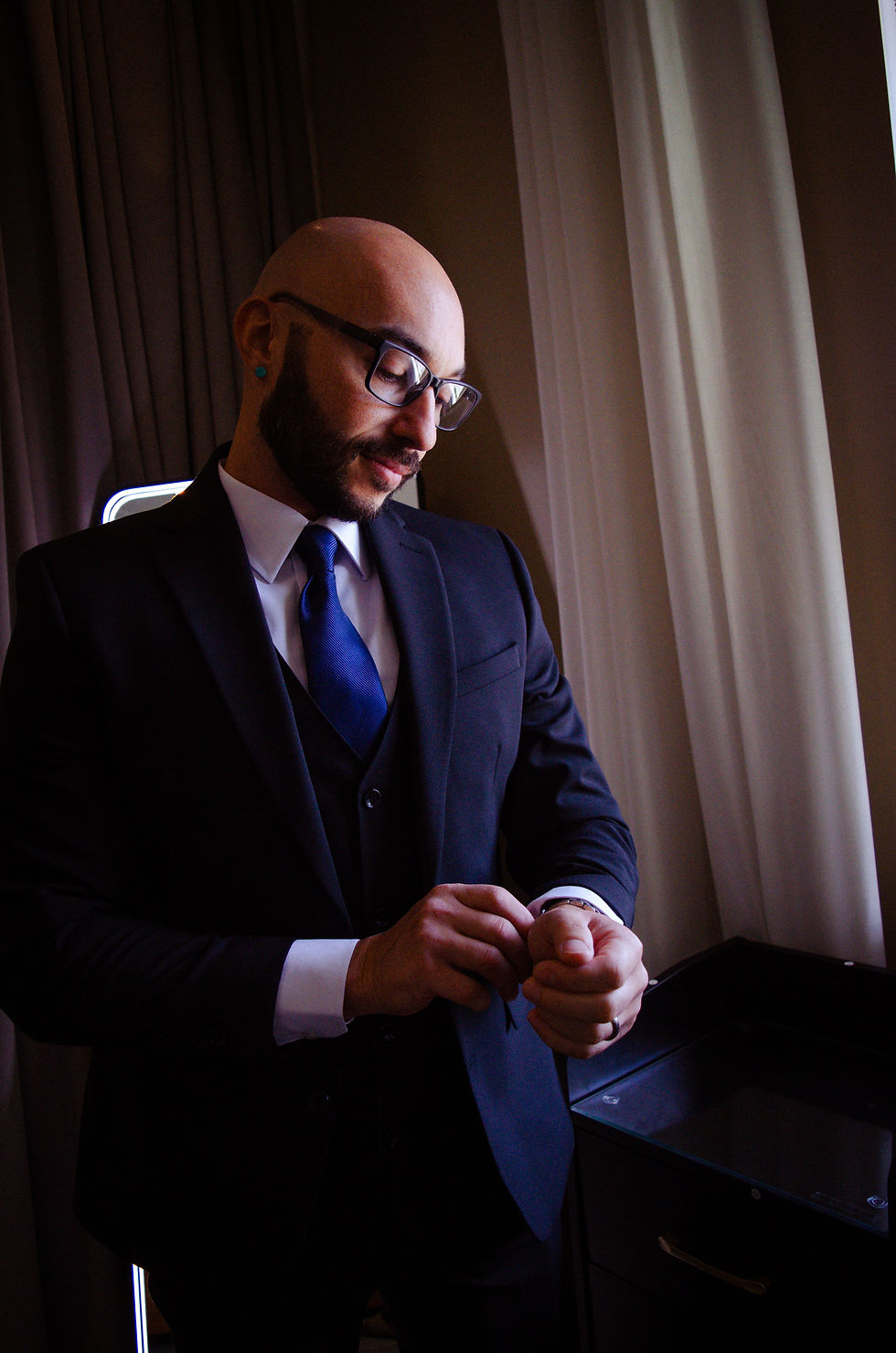 Groom getting ready in wedding suite