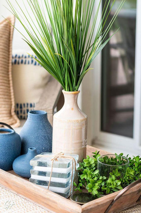Grey driftwood teak dining table and outdoor table decor. Dining table serving tray made of wood with blue ceramic pot accents.