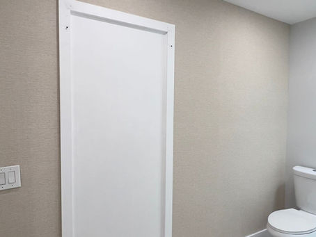 Elegant Miami powder bathroom with textured Eclipse TWC30609 wallpaper and patterned floor tiles by The Wallpaper Company