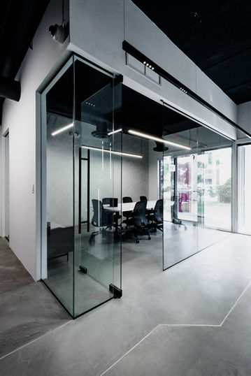 Modern glass-walled private office meeting room