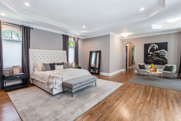 Elegant master bedroom suite with hardwood floors