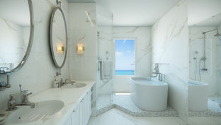Ocean view bathroom: white marble, double vanity, soaking tub