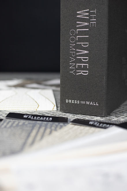 The Wallpaper Company product box and decorative labels, close-up shot.