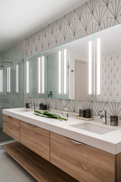 Modern bathroom with double vanity, illuminated mirror