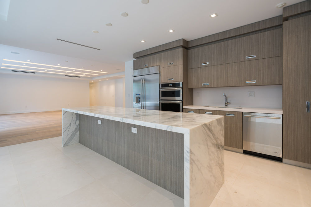 Modern kitchen with marble island, stainless steel appliances