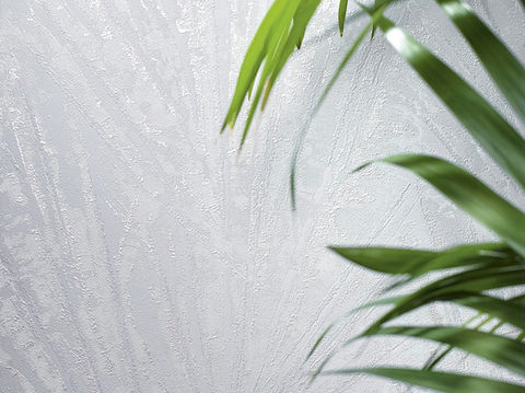 White textured wallpaper sample with plant