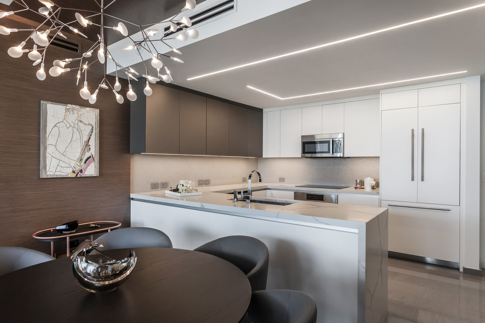 Modern kitchen design: white cabinets, sleek island, and contemporary chandelier