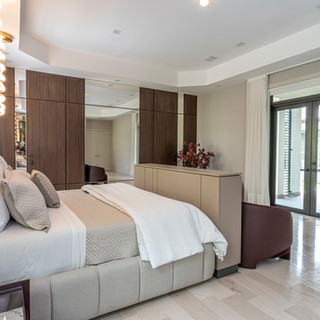 Luxurious bedroom featuring a large bed, elegant decor, and bright natural light.
