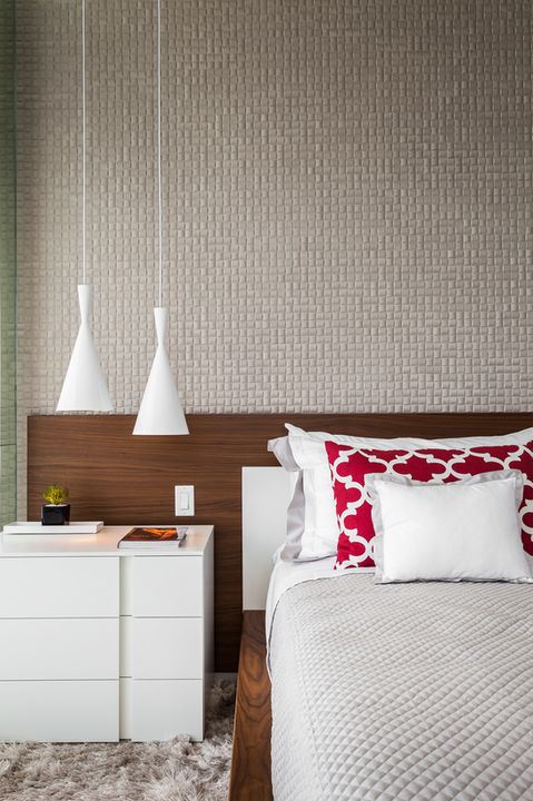 Modern bedroom with white nightstand and red pillows